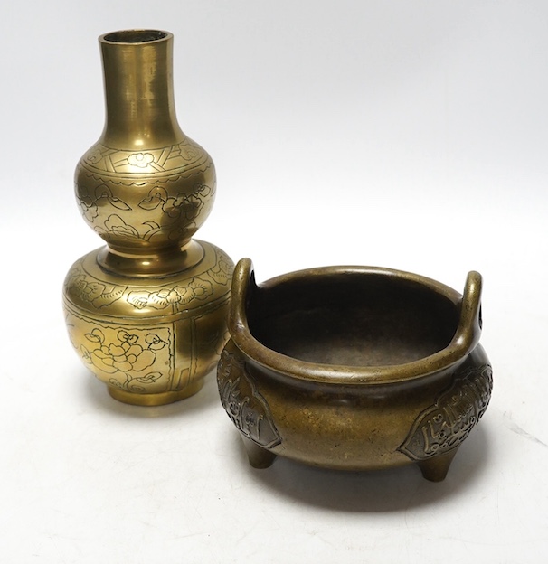 A Chinese bronze tripod censer and a similar double gourd vase, 21cm. Condition - poor to fair, vase has obvious repair to body